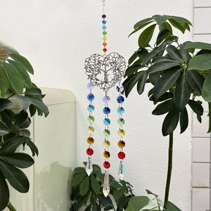 Detail of a silver Tree of Life crystal suncatcher with rainbow chakra beads and prisms