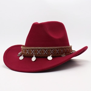 Detail of burgundy felt cowboy hat with ethnic ribbon, gold studs and silver coin charms