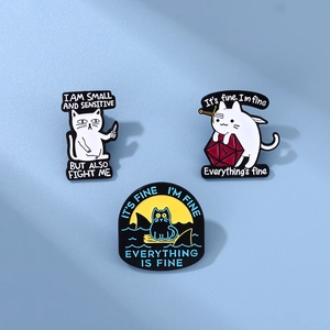 Detailed close-up of three cat enamel pins with humorous English slogans on blue background