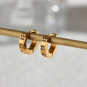 Detail of 18K gold plated stainless steel hoop earrings with star-shaped zircon inlays