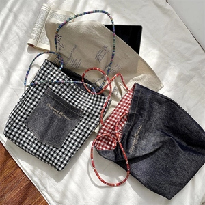 Close-up of retro double-sided denim and gingham tote bags with vibrant beaded straps