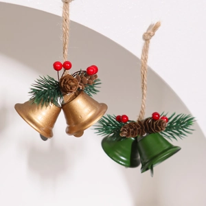 Detailed view of red berries and pine cones on gold and green metal Christmas bells