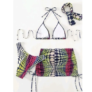 Detail of four-piece swimwear set with polka dot print and drawstring mini skirt
