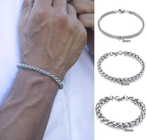 Detailed comparison of 3mm, 6mm and 8mm silver steel braided bracelets on a male wrist