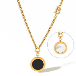 Detail of gold necklace featuring double-sided black and white shell round pendant