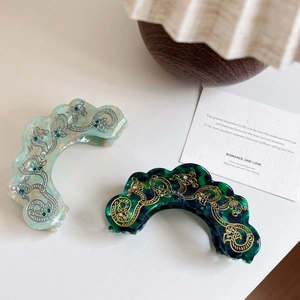Elegant emerald green and marble blue hair claw clips with intricate gold filigree detailing