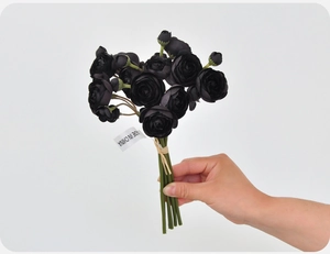 Close-up of artificial black ranunculus bouquet with realistic silk texture and green stems
