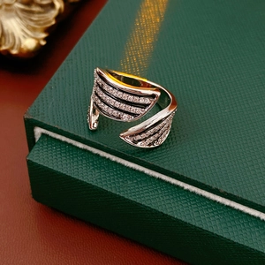Macro shot of wave-shaped ring with black enamel and sparkling zircon on green jewelry box