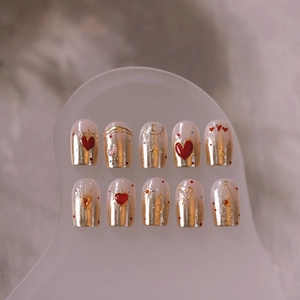 Star and moon nail charms with red hearts on creamy white luxury press-on nails set