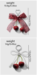 Detail view of cherry keychains with leopard ribbon bow and pearl bow accents