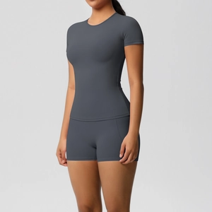 Close-up of slim-fit charcoal grey short-sleeve yoga top and matching high-waisted shorts