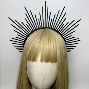 Black halo crown headband featuring sunburst spikes on a model headpiece display