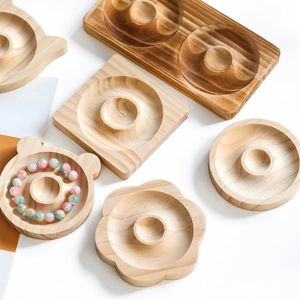 Close-up of assorted wooden jewelry design trays showing smooth natural wood grain textures