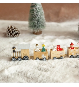 Detail of wooden Christmas train with snowman and Santa figures in snowy winter setting