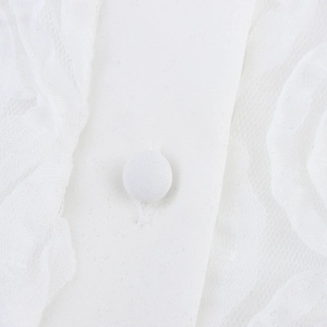 White sweet camisole top with fabric-covered button and delicate lace texture