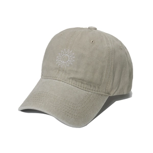 Detailed macro of sun and moon embroidery on a vintage washed cotton baseball cap