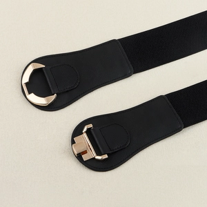 Detail of black elastic waist belts with gold geometric metal buckles and faux leather accents