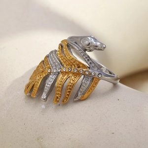 Macro shot of two-tone fishbone ring with gold and silver plating and sparkling zircons