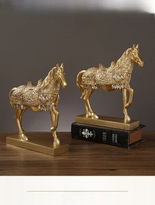 Close-up of golden horse resin statue featuring intricate carvings and colorful rhinestones
