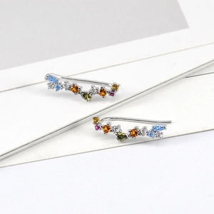 Detailed macro view of silver ear crawlers featuring multi-colored marquise cut zircons