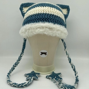 Detail of striped crochet cat ear beanie with faux fur trim and star pendants