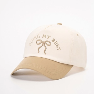 Two-tone baseball cap in cream and khaki with Doing My Best embroidery and bow design