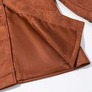 Detail of brown suede jacket hem showing premium stitching and smooth inner lining