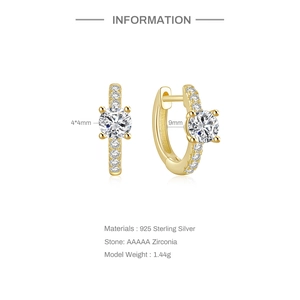 Macro view of S925 silver gold-plated hoop earrings with clear cubic zirconia stones
