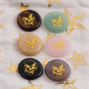 Flat round gemstones in various colors with golden skull engravings in 2x3 grid