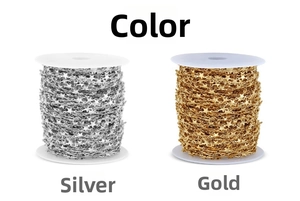 Detail view of gold and silver star-shaped stainless steel chains on white spools