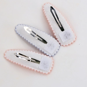 Three teardrop snap hair clips in pink and light blue with felt backing on white background