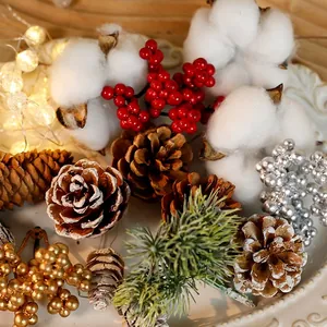 Christmas decor set with pine cones, cotton, red berries and pine needles on a plate