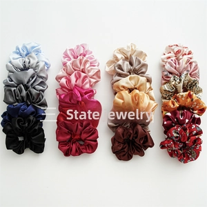 Set of 24 satin fabric hair scrunchies in assorted solid colors and floral prints