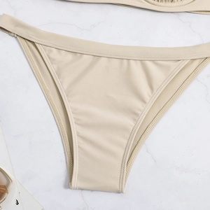Detail of light champagne bikini bottoms with refined horizontal texture and neat stitching