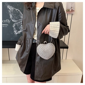 Elegant heart-shaped evening bag with shimmering rhinestones and a metal chain strap