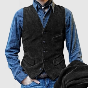 Close-up of vintage corduroy texture on dark brown workwear vest with buttons
