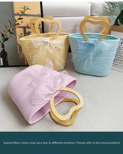 Detail of woven cotton bags with heart-shaped wooden handles and matching organza bows