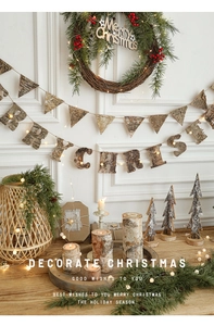 Detail of wooden Merry Christmas sign and pine wreath with birch bark holiday ornaments