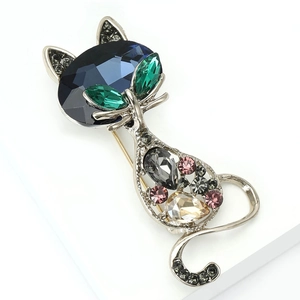 Detailed close-up showing intricate crystal inlay on the cat-shaped silver brooch