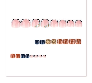 Detailed set of 3D decorative toe nail tips with gold beads, blue glitter, and cow prints