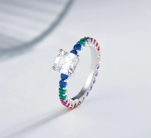 Macro detail of 925 silver ring featuring Asscher cut diamond and colorful pavé stones