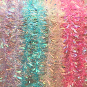 Iridescent Christmas tinsel garlands in pink and blue for festive tree decoration
