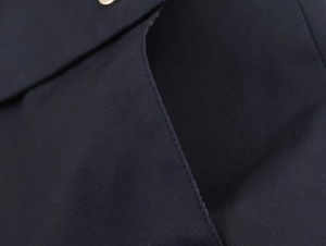 Detailed view of navy blue twill fabric texture and precision stitching on the hoody
