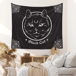 Close-up of bohemian style black cat wall tapestry hanging in a cozy bedroom
