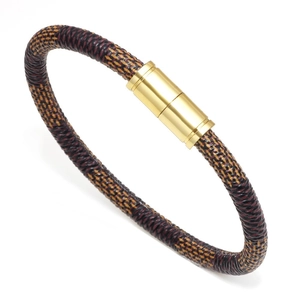 Gros plan d'un bracelet bohème en cuir tressé avec fermoir magnétique doré brillant
