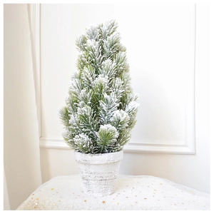 Close-up of a 45cm mini flocked Christmas tree with realistic snow on a vintage white pot