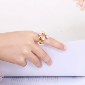 Close-up of 18K gold-plated stainless steel ring with four clear round zircons