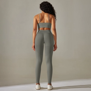 Detail view of seamless sage green yoga set with cross straps and high waist leggings
