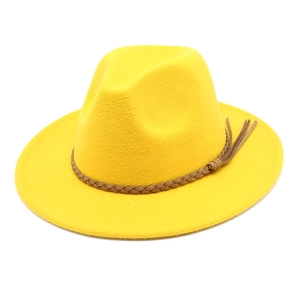 Detail of yellow wool fedora hat with brown braided tassel band on white background