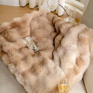 Detailed texture of thick luxury faux fur blanket in light brown for sofa and bedroom